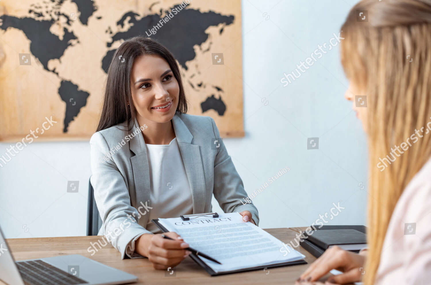 stock photo smiling travel agent showing signature place in contract to client 1590145093 e1681243730187